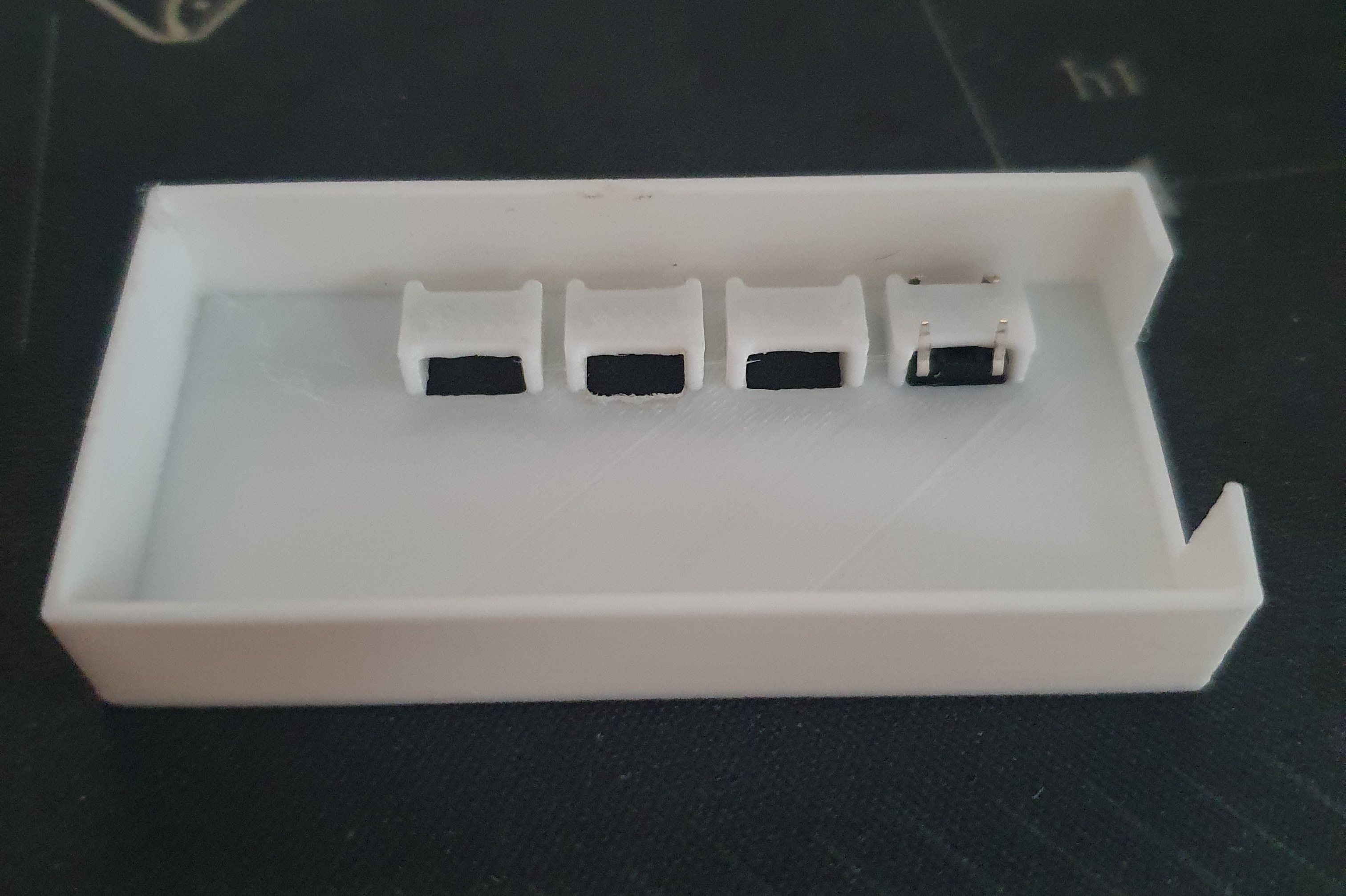 Top of the case, with the buttons on it